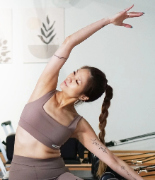 Amber Ku, Repose Pilates instructor, in a side stretch