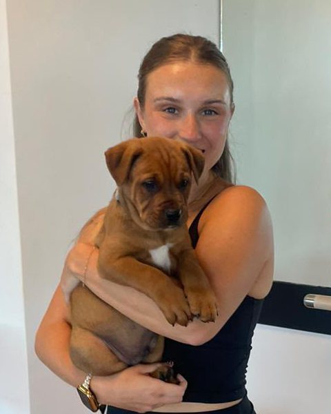 Katie Williamson, Repose Pilates instructor, holding a puppy